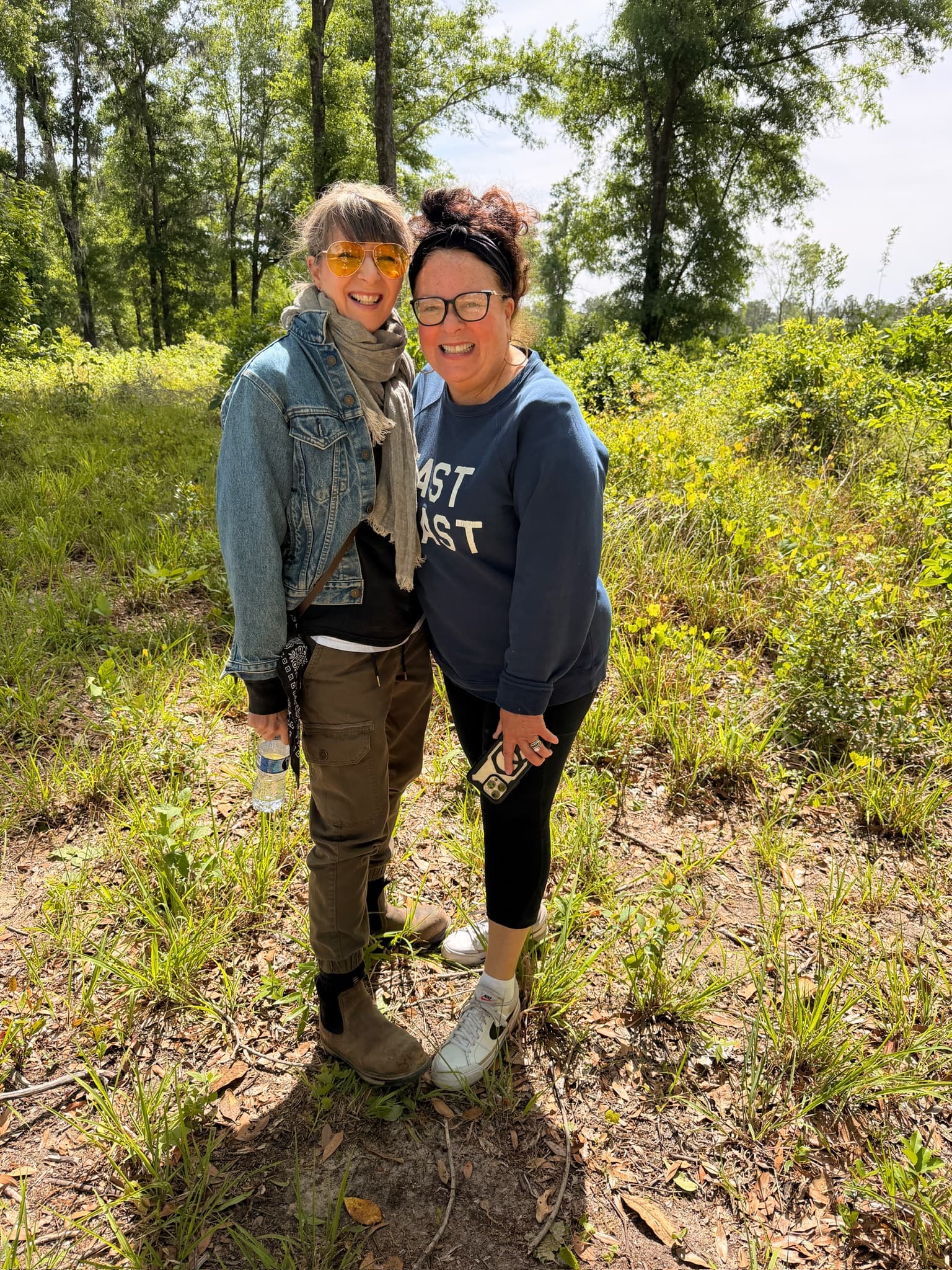 A couple standing together in a green meadow at the ranch