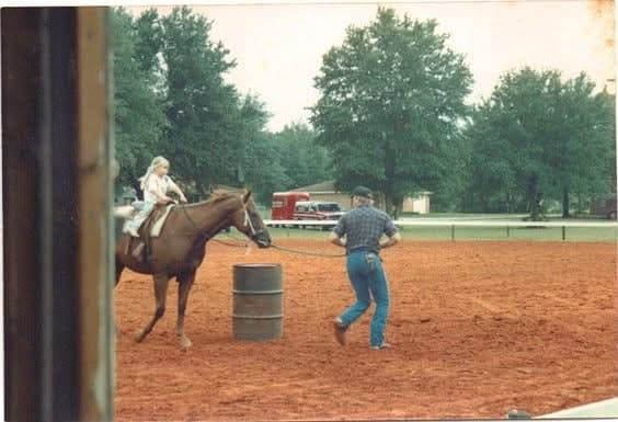 A young Jill barrel racing on horseback